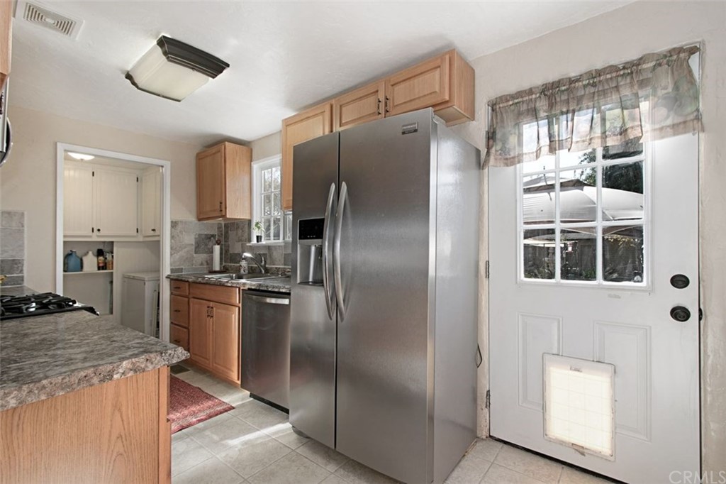 4256 9th Street Riverside, CA 92501 - Photo 12 of 40 a kitchen with stainless steel appliances granite countertop a refrigerator and a stove