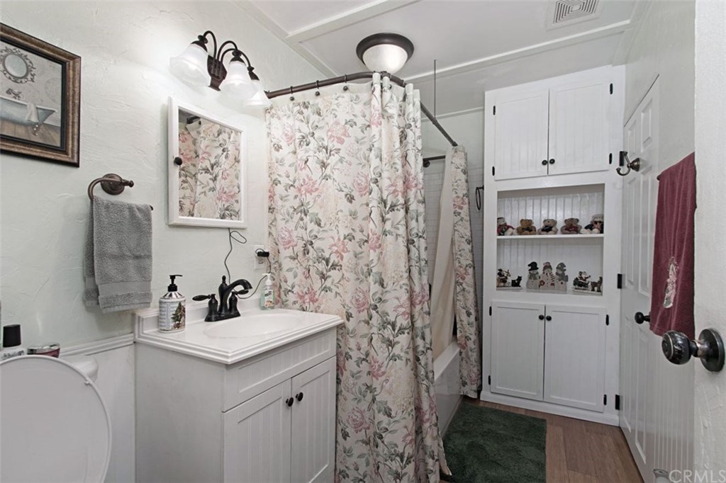 4256 9th Street Riverside, CA 92501 - Photo 19 of 40 a bathroom with sink a mirror a shower and vanity
