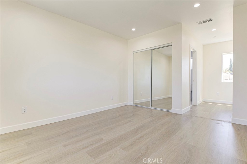 7044-2 Greeley Street Tujunga, CA 91042 - Photo 19 of 20 a view of an empty room with wooden floor