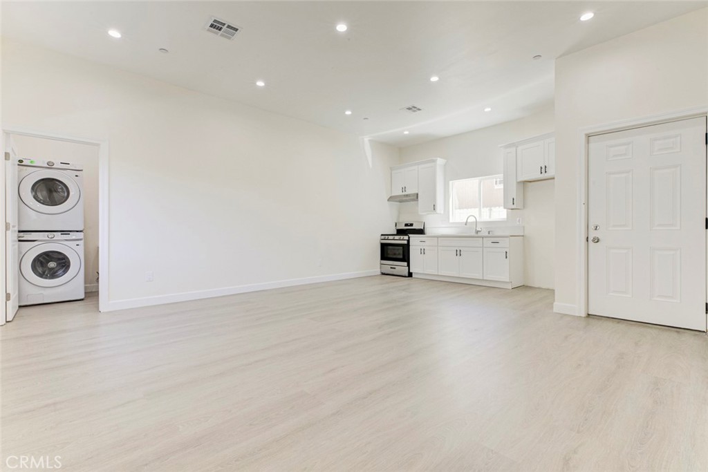 7044-2 Greeley Street Tujunga, CA 91042 - Photo 3 of 20 an empty room with a washer and dryer