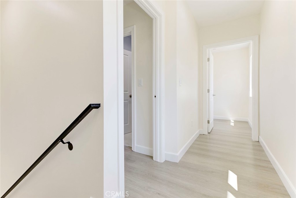 7044-2 Greeley Street Tujunga, CA 91042 - Photo 9 of 20 a view of a hallway with wooden floor and staircase