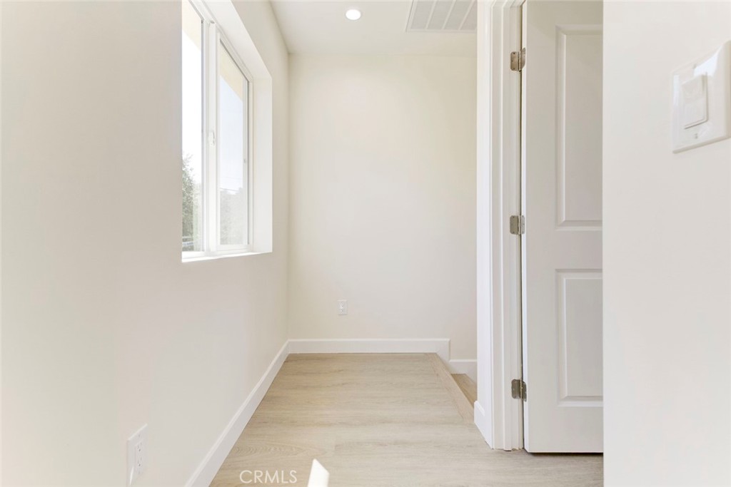7044-2 Greeley Street Tujunga, CA 91042 - Photo 10 of 20 a view of an empty room with wooden floor and a window