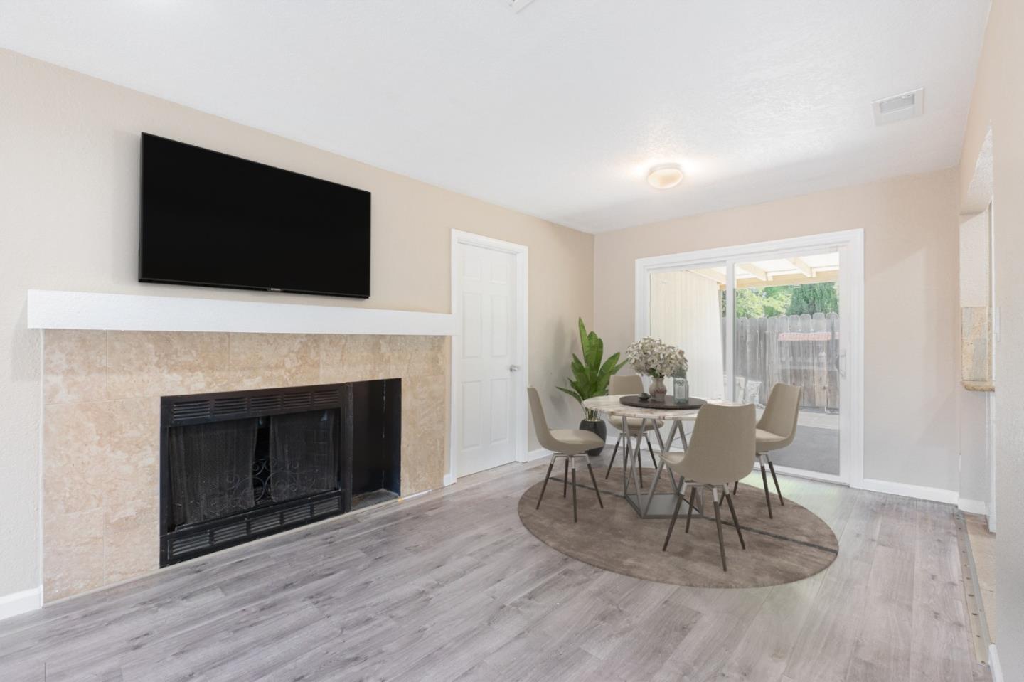 3490 Royal Road Concord, CA 94519 - Photo 5 of 17 a dining room with a fireplace a flat screen tv and a fireplace