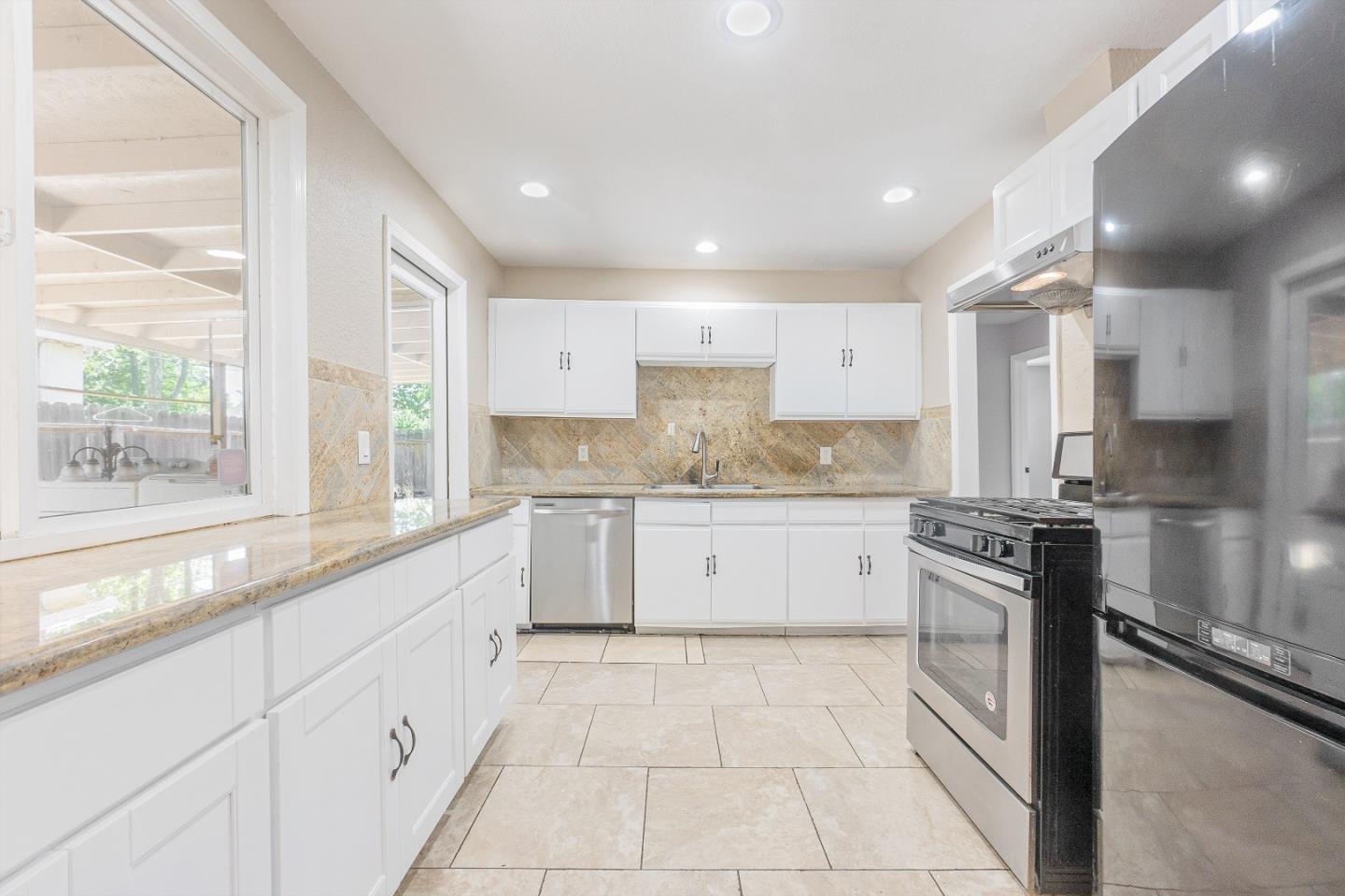 3490 Royal Road Concord, CA 94519 - Photo 7 of 17 a large kitchen with granite countertop white cabinets and stainless steel appliances