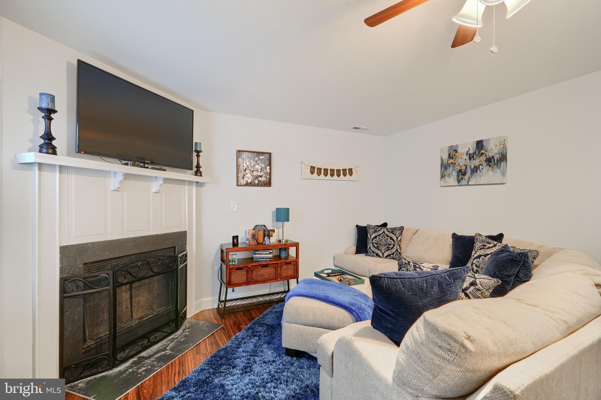 40 Surrey Lane, Unit 122 Nottingham, MD 21236 - Photo 12 of 31 a living room with furniture a flat screen tv and a fireplace
