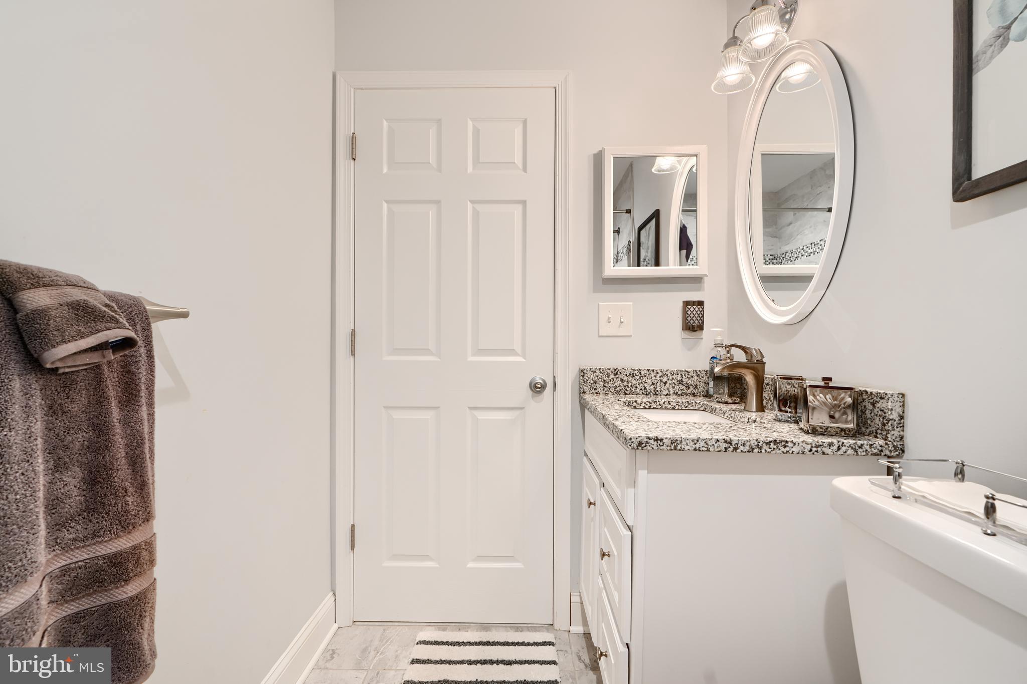 40 Surrey Lane, Unit 122 Nottingham, MD 21236 - Photo 22 of 31 a bathroom with a sink and a mirror