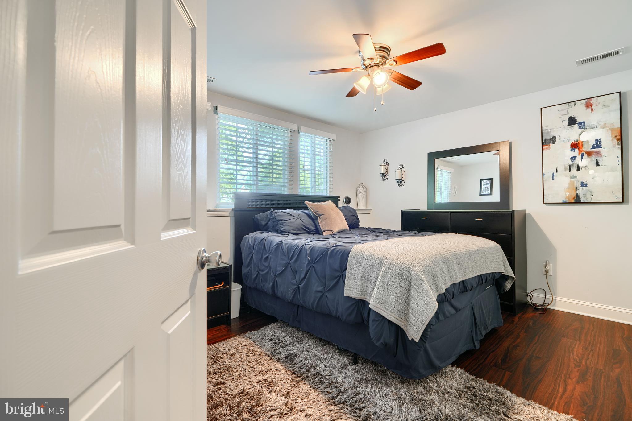 40 Surrey Lane, Unit 122 Nottingham, MD 21236 - Photo 23 of 31 a bedroom with a large bed and a chandelier