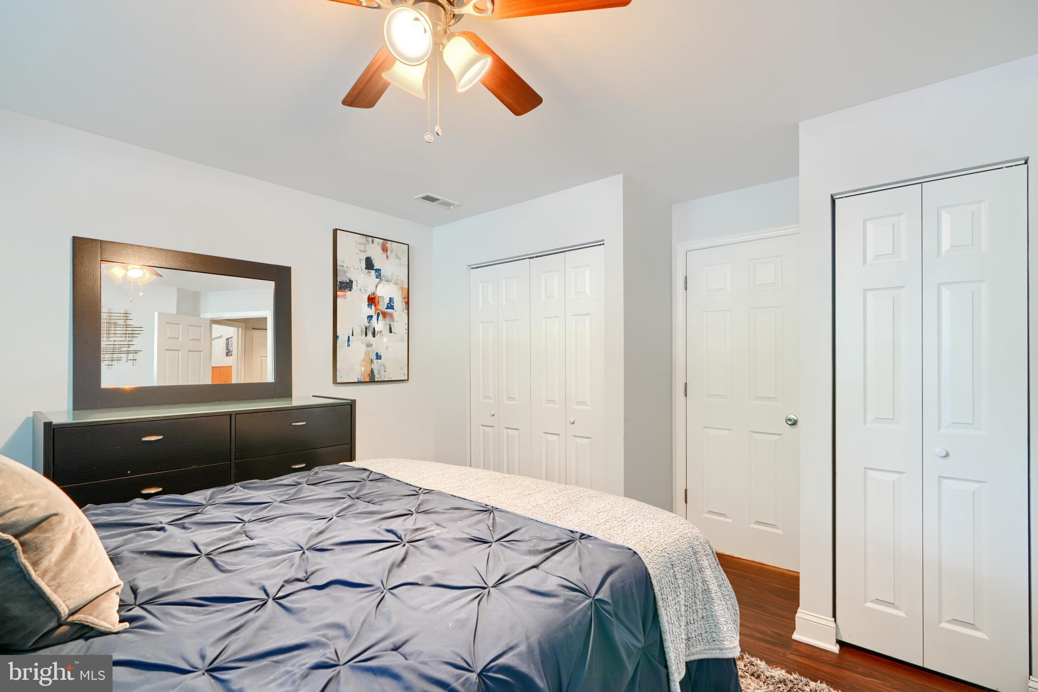 40 Surrey Lane, Unit 122 Nottingham, MD 21236 - Photo 25 of 31 a bedroom with a bed and wooden floor