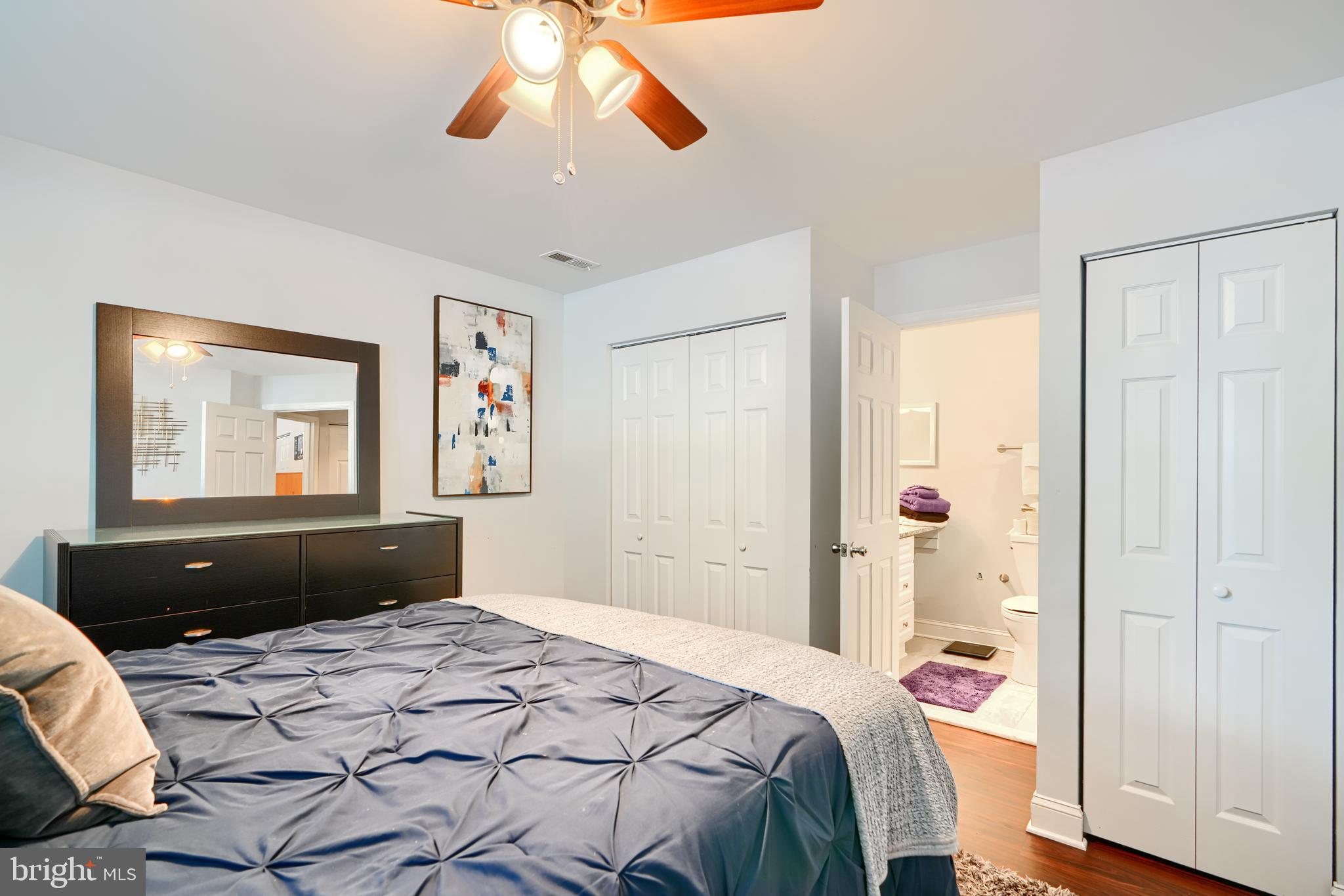40 Surrey Lane, Unit 122 Nottingham, MD 21236 - Photo 26 of 31 a bedroom with a bed and wooden floor