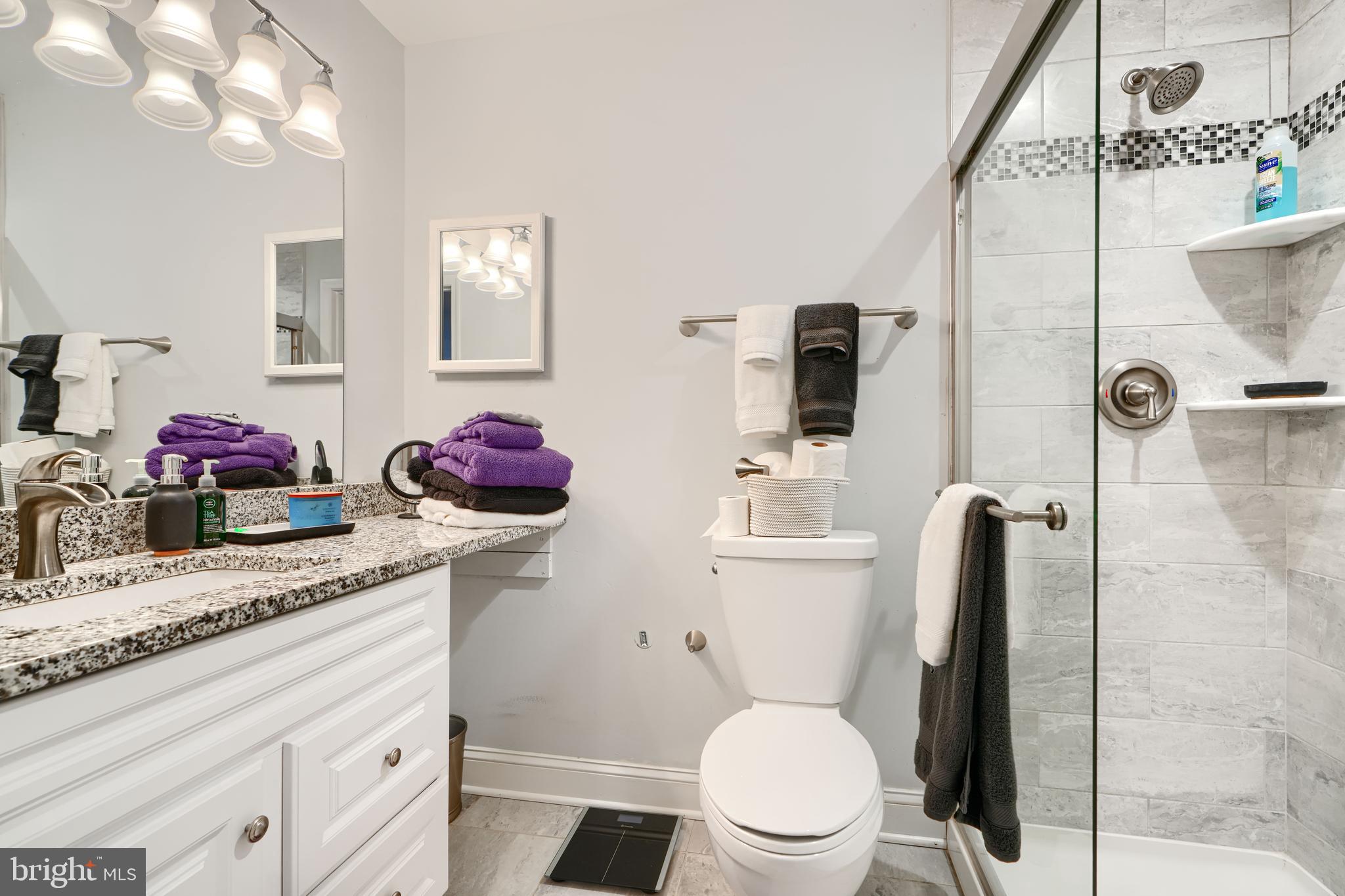 40 Surrey Lane, Unit 122 Nottingham, MD 21236 - Photo 27 of 31 a bathroom with a granite countertop sink mirror vanity and toilet