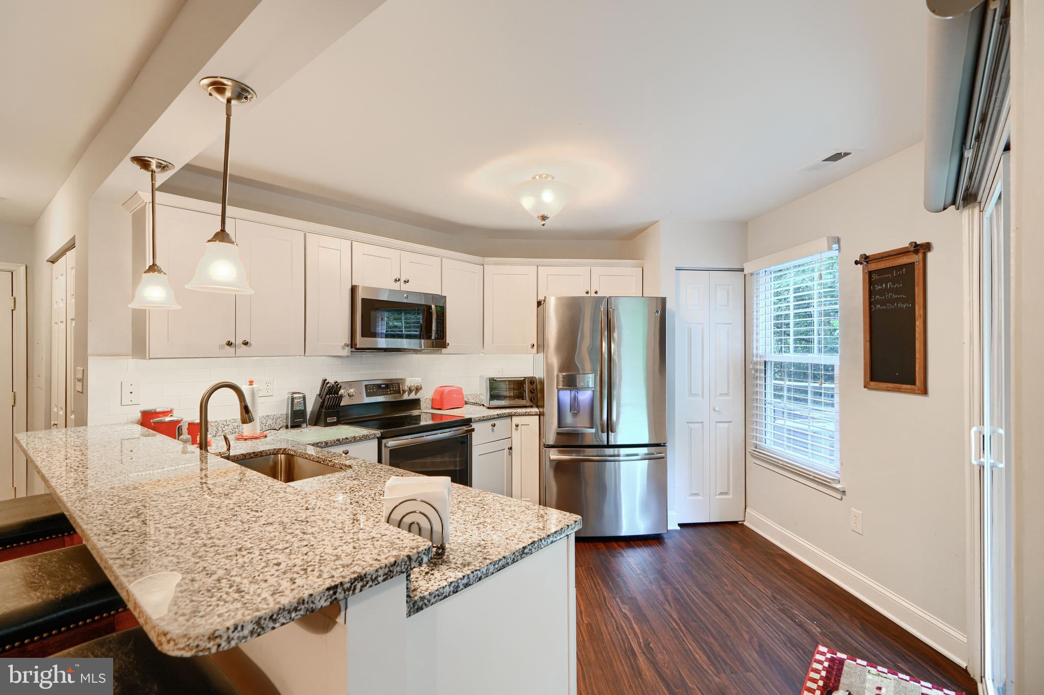 40 Surrey Lane, Unit 122 Nottingham, MD 21236 - Photo 6 of 31 a kitchen with stainless steel appliances granite countertop a refrigerator sink and microwave