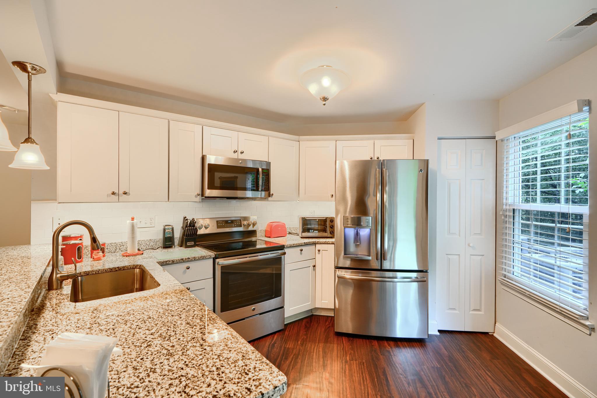 40 Surrey Lane, Unit 122 Nottingham, MD 21236 - Photo 7 of 31 a kitchen with stainless steel appliances granite countertop a refrigerator stove and sink