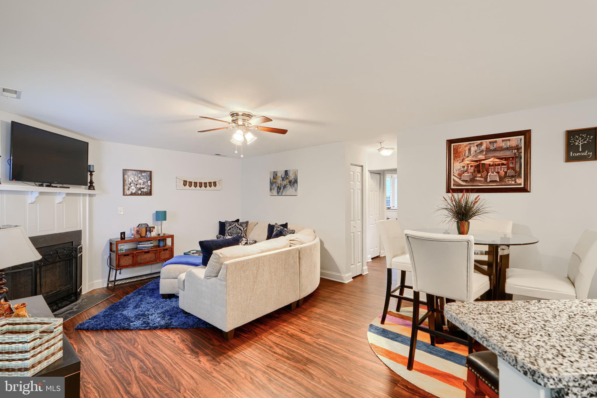 40 Surrey Lane, Unit 122 Nottingham, MD 21236 - Photo 10 of 31 a living room with fireplace furniture and a flat screen tv