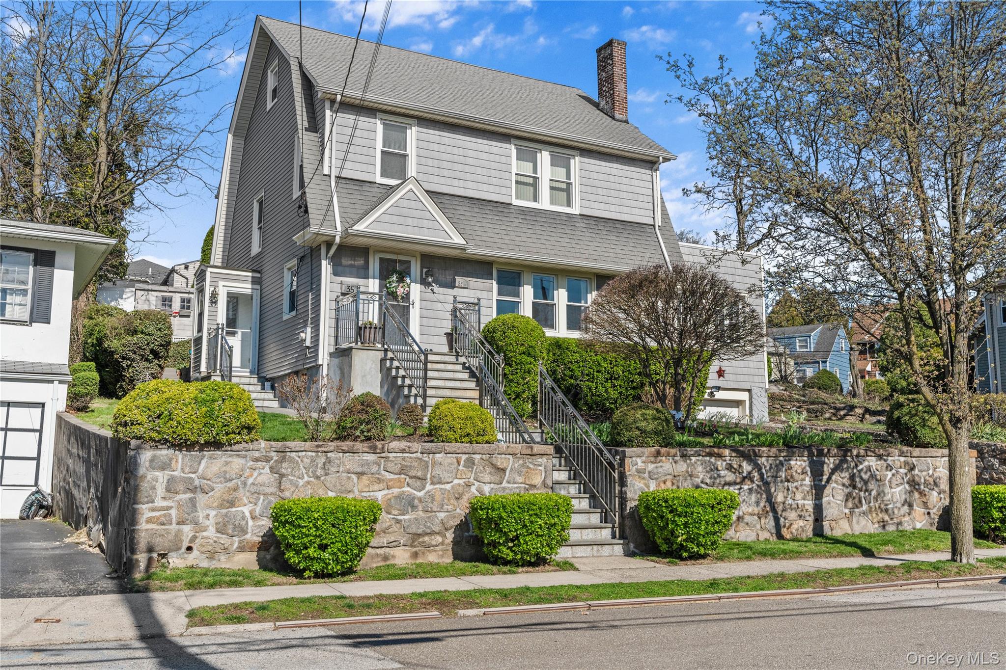 35 Lispenard Avenue New Rochelle, NY 10801 - Photo 1 of 37 a front view of a house with a garden