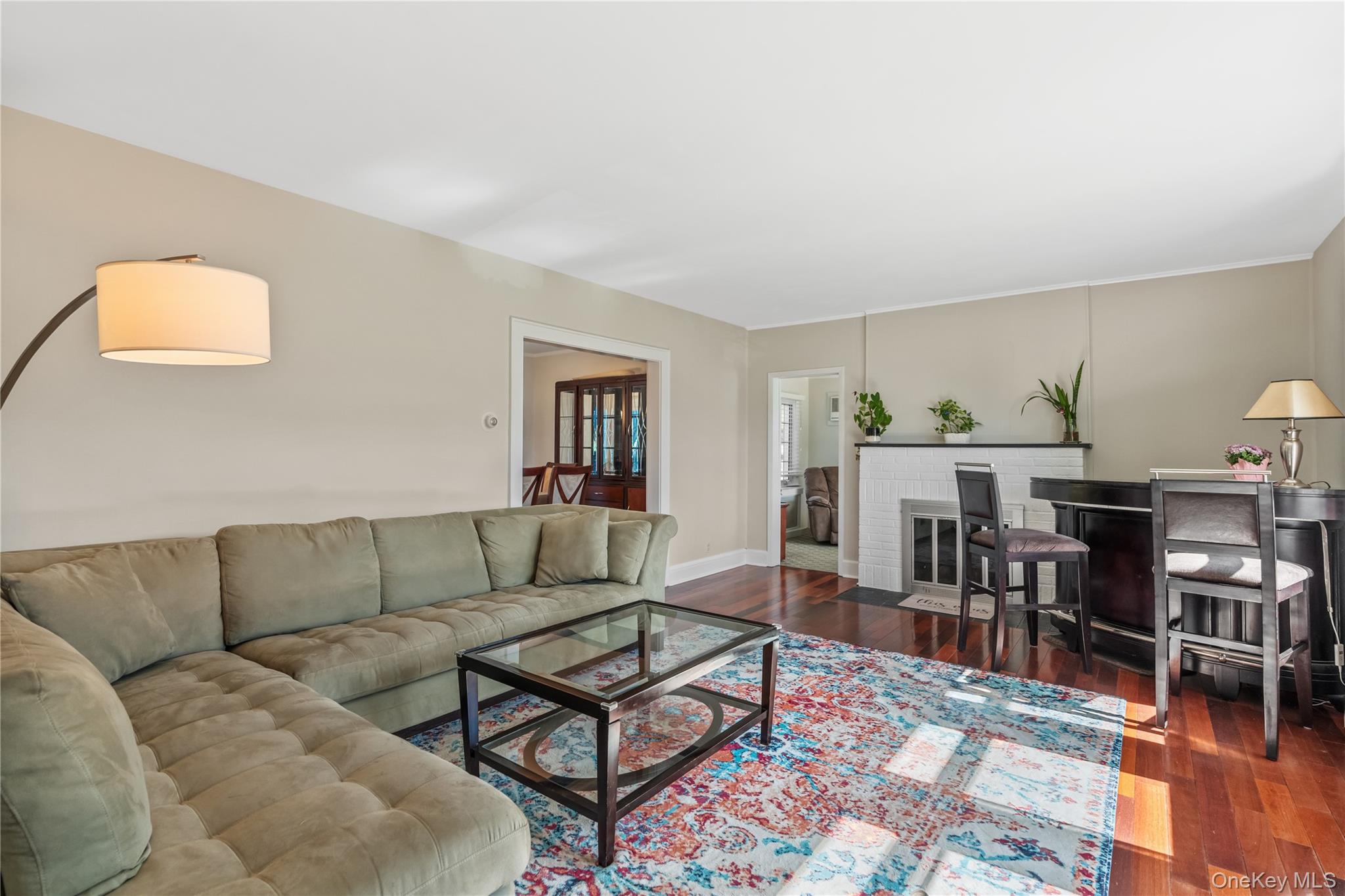 35 Lispenard Avenue New Rochelle, NY 10801 - Photo 12 of 37 a living room with furniture a dining table and chairs with wooden floor
