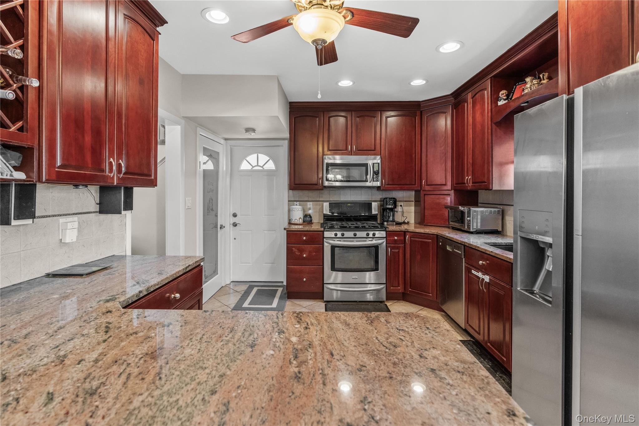 35 Lispenard Avenue New Rochelle, NY 10801 - Photo 2 of 37 a kitchen with stainless steel appliances kitchen island granite countertop a stove sink and cabinets
