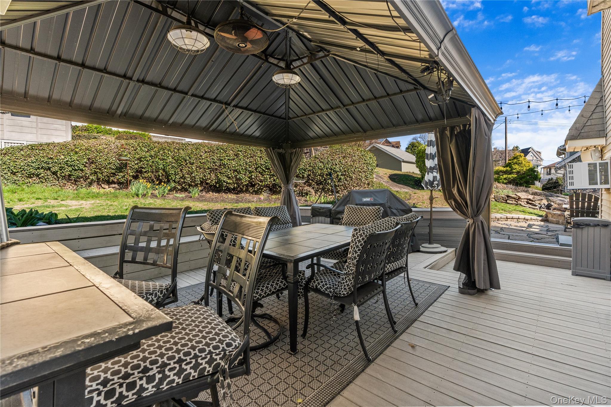 35 Lispenard Avenue New Rochelle, NY 10801 - Photo 32 of 37 a view of a patio with table and chairs under an umbrella with a barbeque