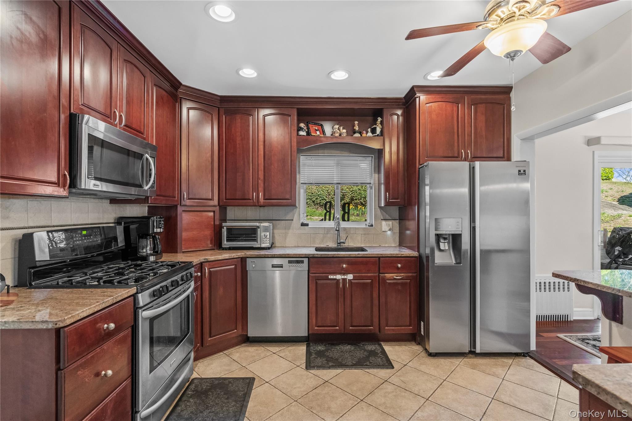 35 Lispenard Avenue New Rochelle, NY 10801 - Photo 4 of 37 a kitchen with stainless steel appliances granite countertop a refrigerator a sink a stove a microwave and wooden cabinets