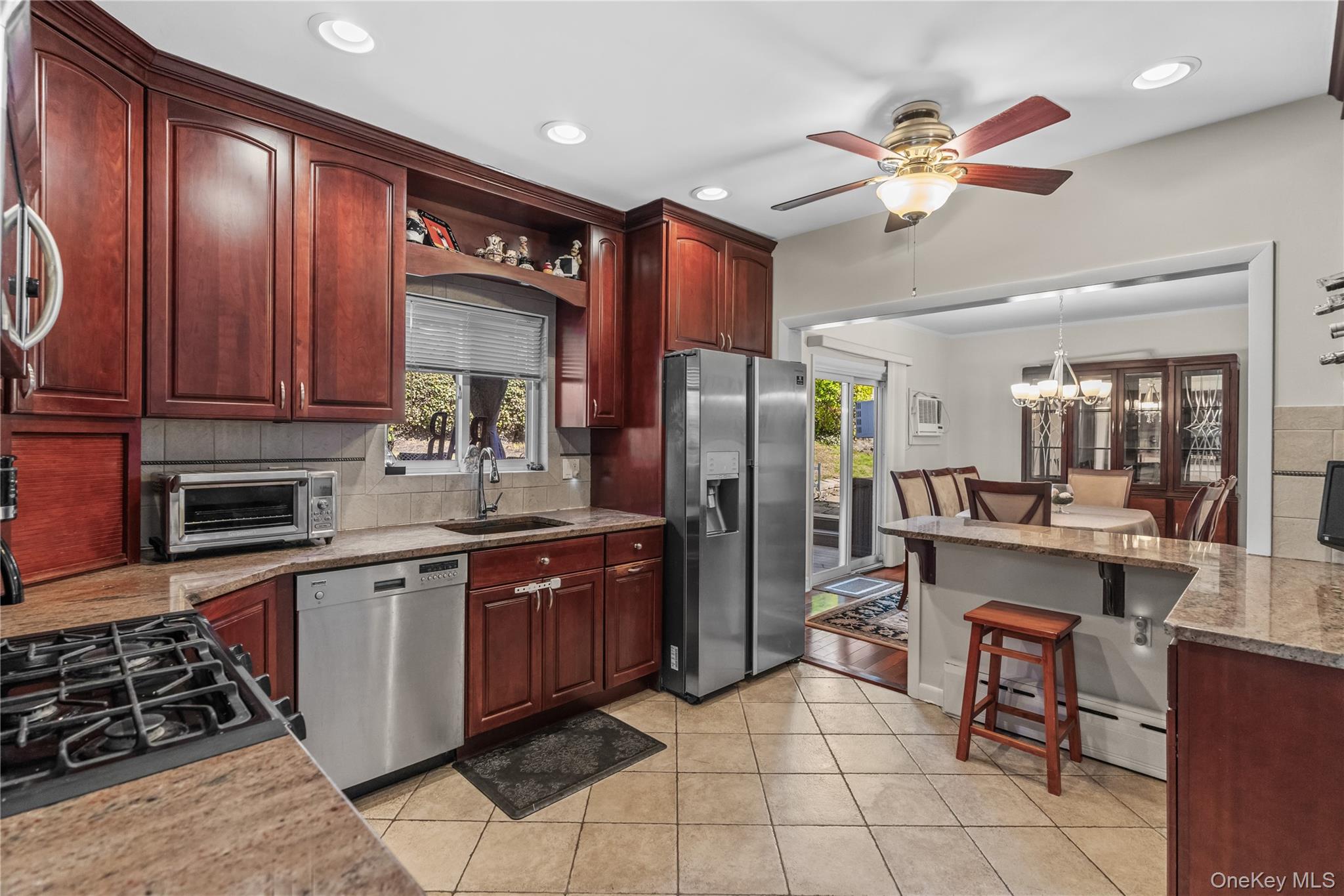 35 Lispenard Avenue New Rochelle, NY 10801 - Photo 5 of 37 a kitchen with stainless steel appliances granite countertop a stove refrigerator and cabinets