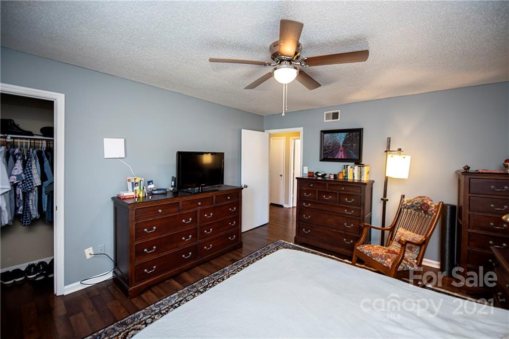 1911 Smoke Ridge Court Charlotte, NC 28210 - Photo 12 of 15 a room with a dresser and a flat screen tv