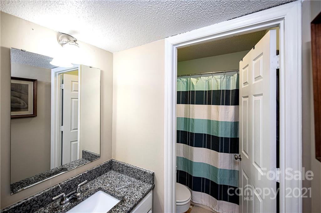 1911 Smoke Ridge Court Charlotte, NC 28210 - Photo 13 of 15 a bathroom with a sink a toilet a shower and a mirror