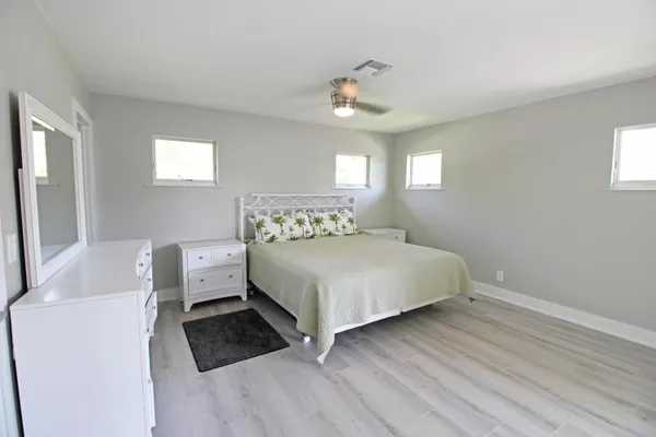 a bedroom with a bed and a large window