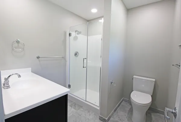 a bathroom with a shower and a sink