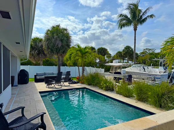 a view of a house with a patio and a yard