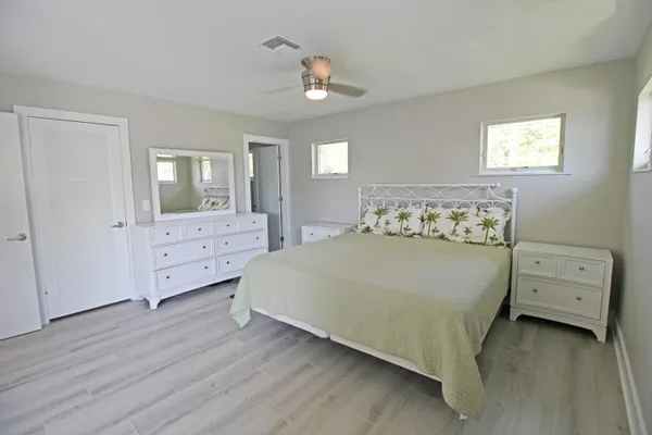 a bedroom with a bed and a night stand