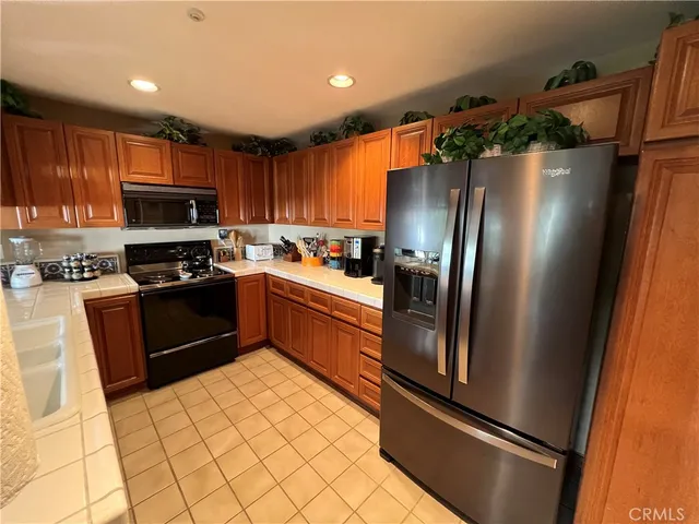 a kitchen with stainless steel appliances granite countertop a refrigerator stove and microwave