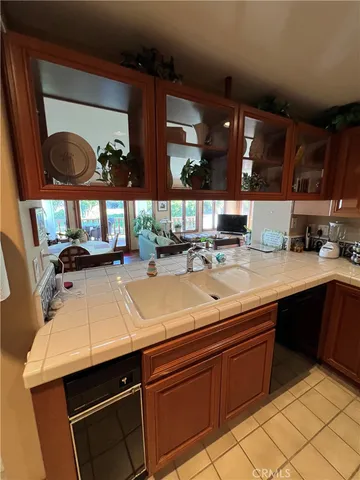 a room with kitchen island a sink and a stove