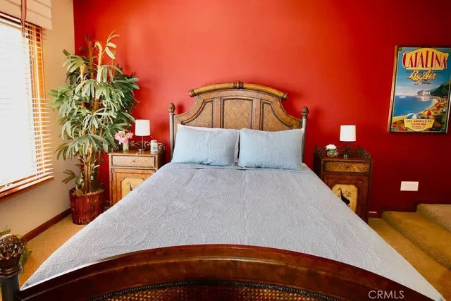 a bedroom with a bed and a potted plant