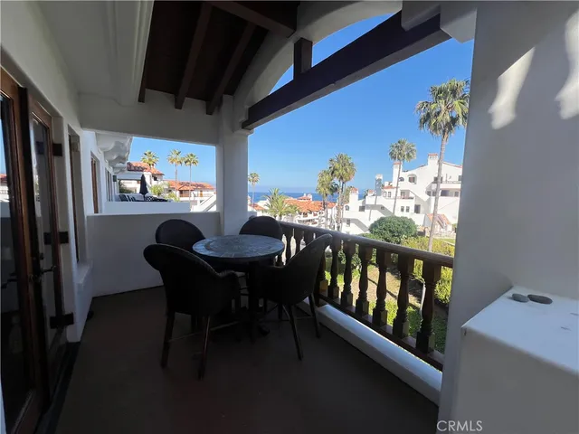a view of a dining room with furniture a chandelier and wooden floor