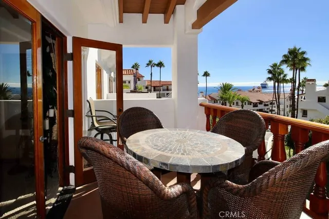 a dining room with furniture and a floor to ceiling window