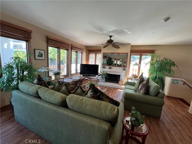 a living room with furniture a large window and a fireplace