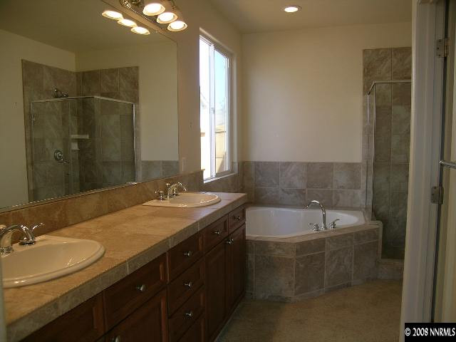 1705 Canyon Shadow Circle Reno, NV 89521 - Photo 5 of 8 a bathroom with a double vanity sink and a bathtub