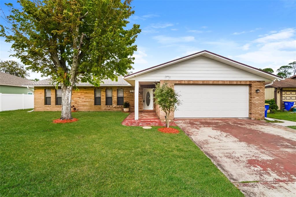 a front view of house with yard and green space