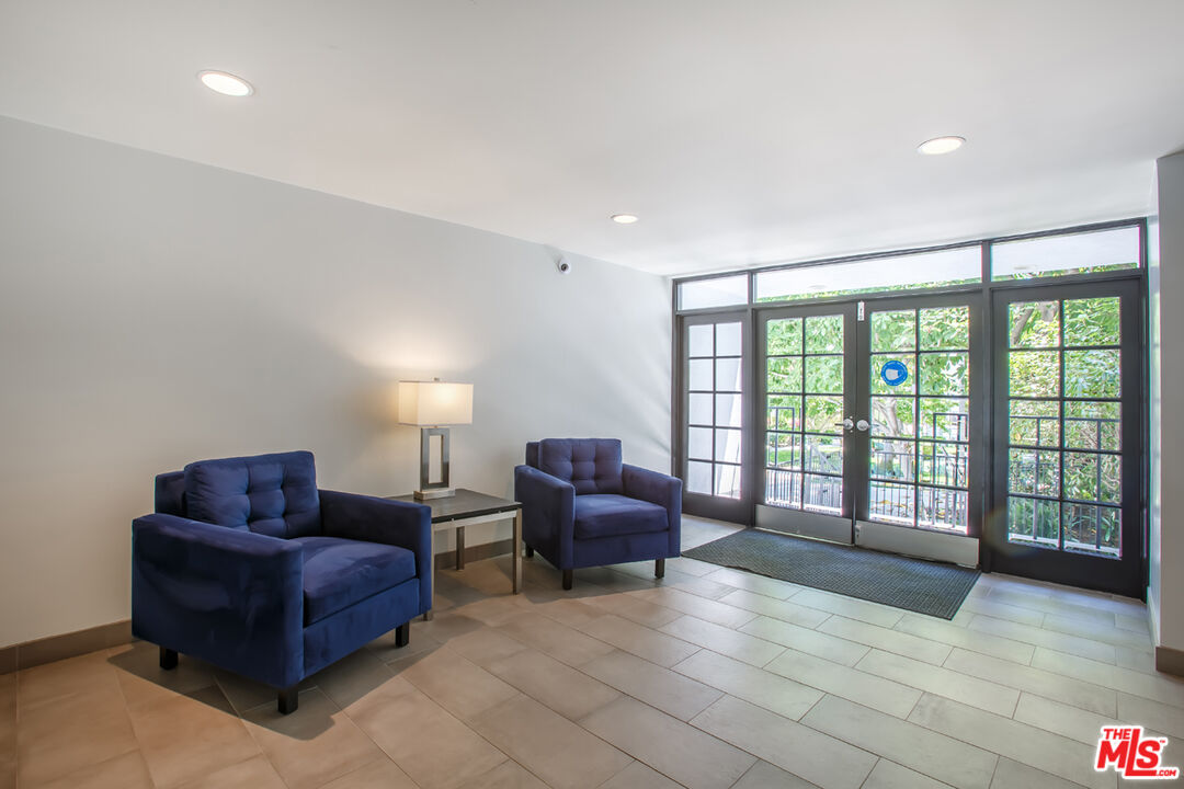848 North Kings Road, Unit 208 West Hollywood, CA 90069 - Photo 30 of 30 a living room with furniture and a floor to ceiling window