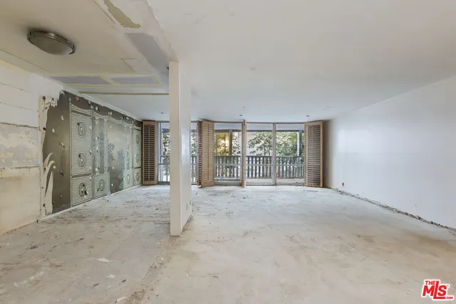 a living room with furniture and a floor to ceiling window