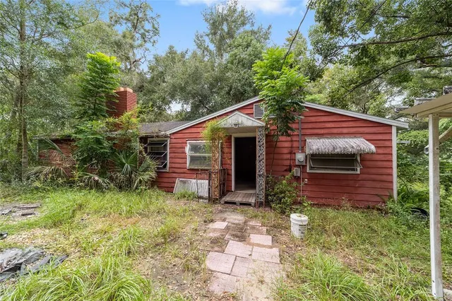 a view of a house with a yard and sitting area