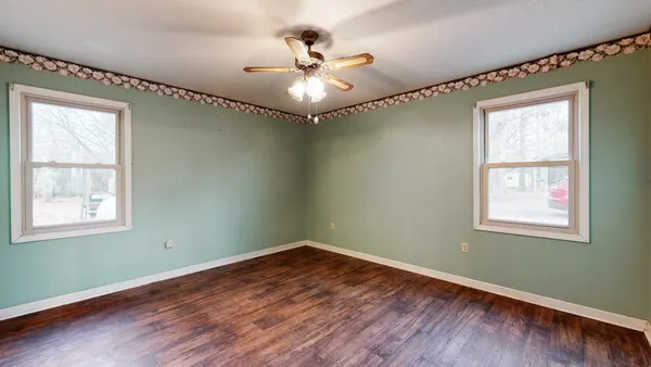 a room with window and ceiling fan