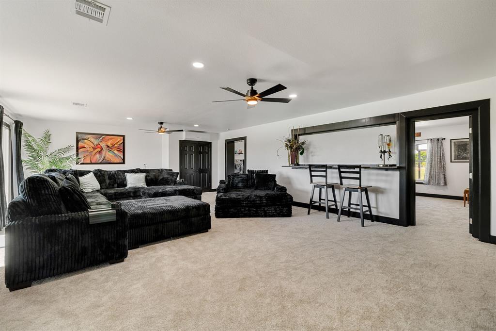 12240 Wellington Road Ponder, TX 76259 - Photo 18 of 40 Spacious room with light-colored carpeting, recessed lighting, and two ceiling fans