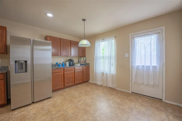a kitchen with refrigerator and window