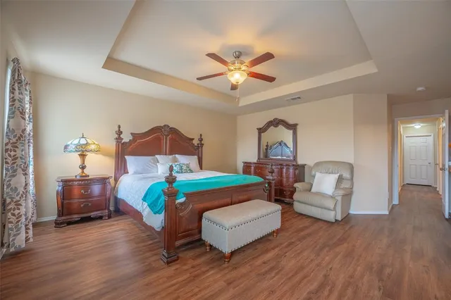 a bedroom with furniture and a wooden floor