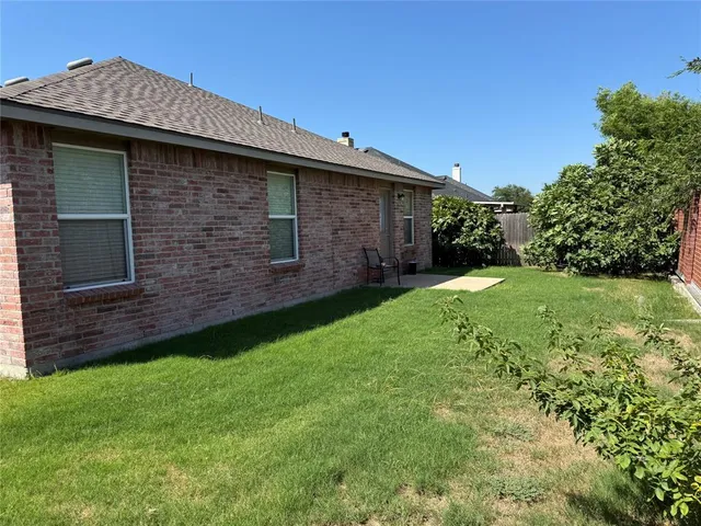 a brick building with a yard
