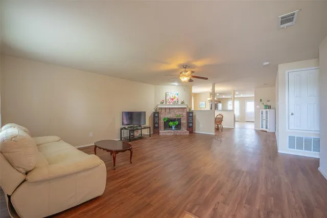 a living room with furniture and a kitchen view
