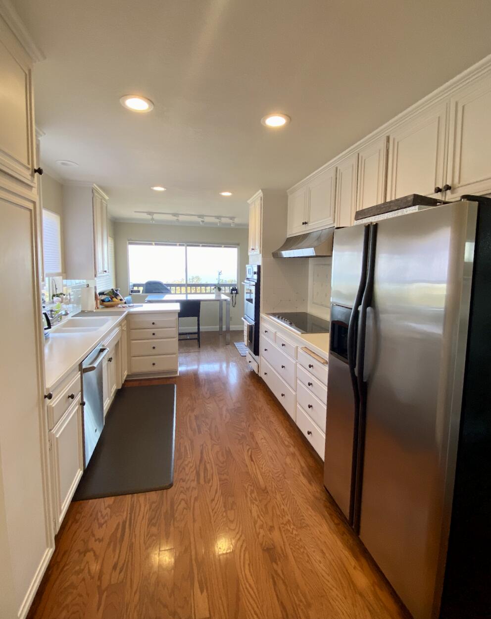 174 Coronada Circle Santa Barbara, CA 93108 - Photo 2 of 33 a kitchen with stainless steel appliances granite countertop a refrigerator a sink dishwasher a stove and white countertops with wooden floor