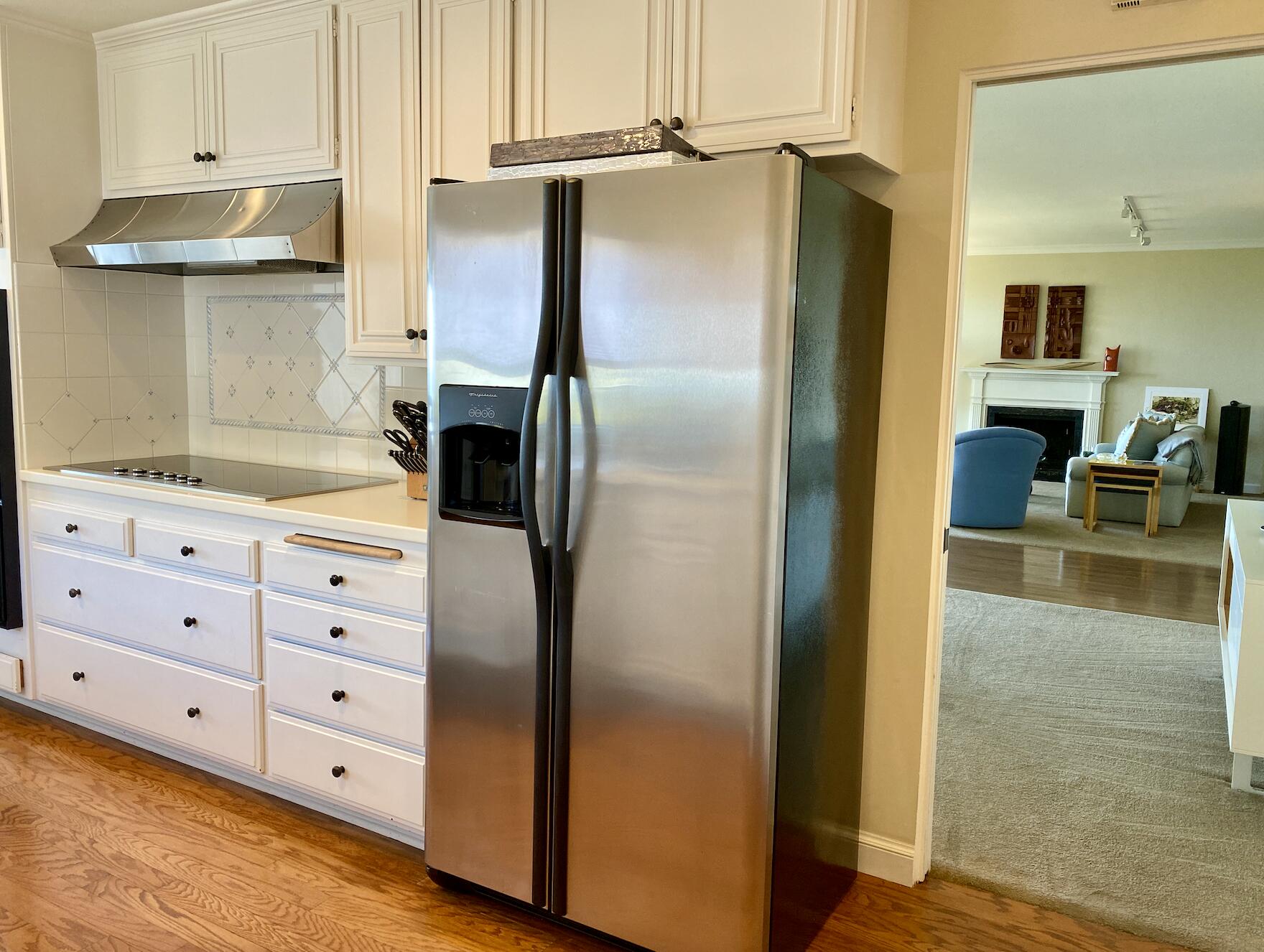 174 Coronada Circle Santa Barbara, CA 93108 - Photo 3 of 33 a kitchen with white cabinets and refrigerator