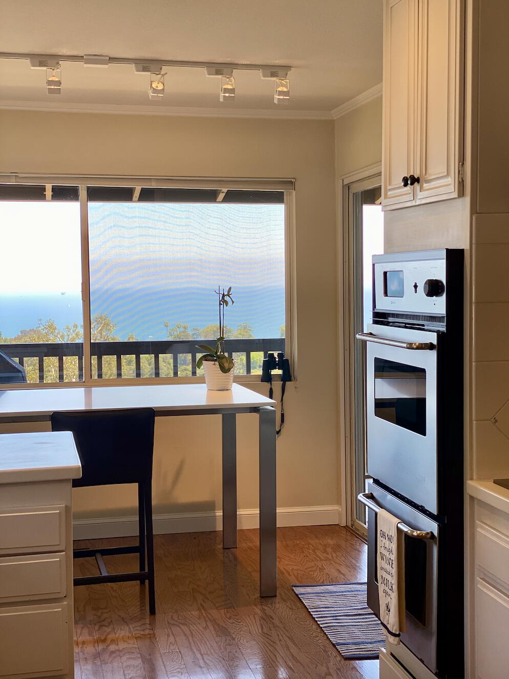 174 Coronada Circle Santa Barbara, CA 93108 - Photo 4 of 33 a hallway with a stove and a microwave oven