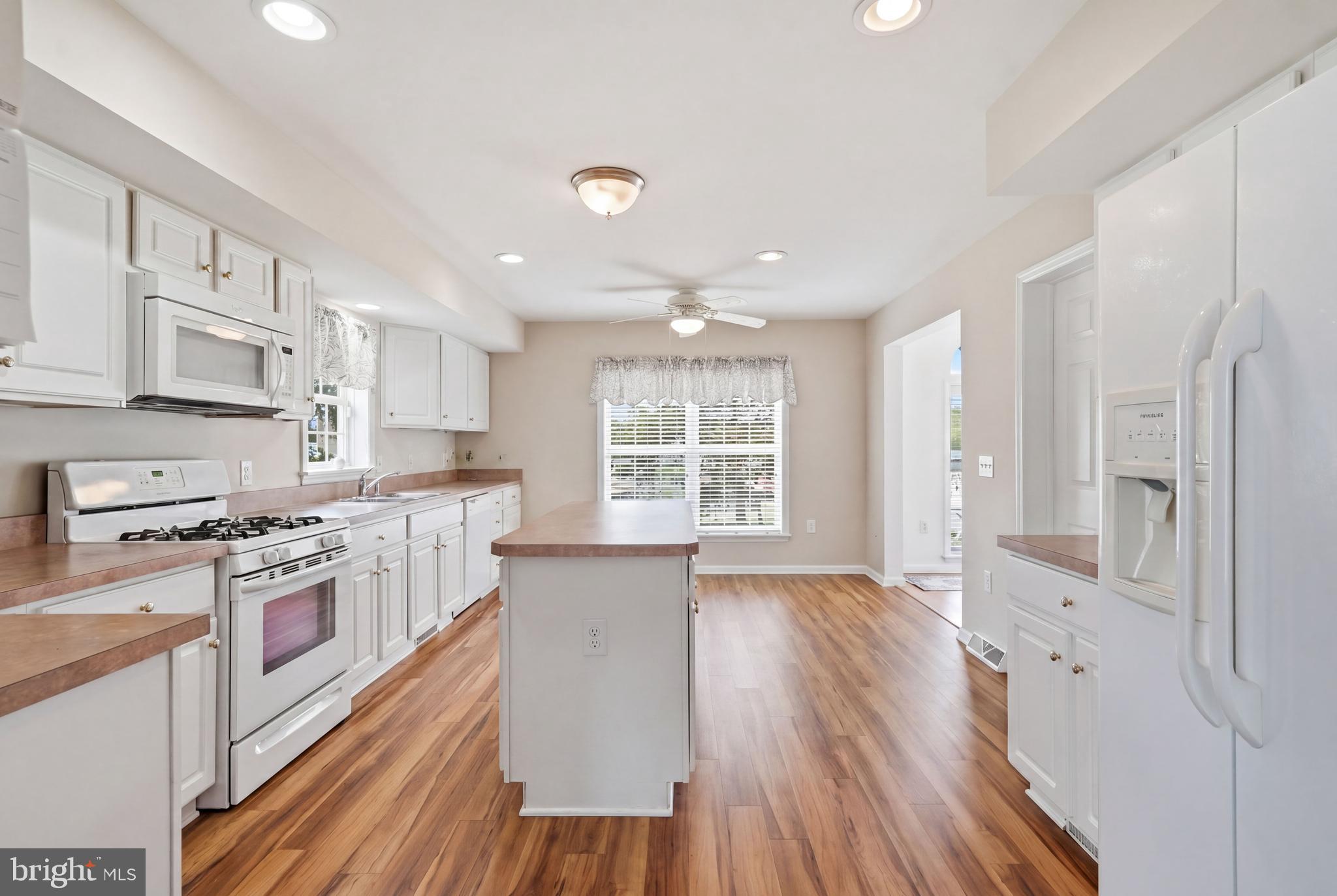 430 Rt Us 9 Street South, Unit 137 Marmora, NJ 08223 - Photo 7 of 24 a large kitchen with stainless steel appliances granite countertop a lot of counter space and wooden floors